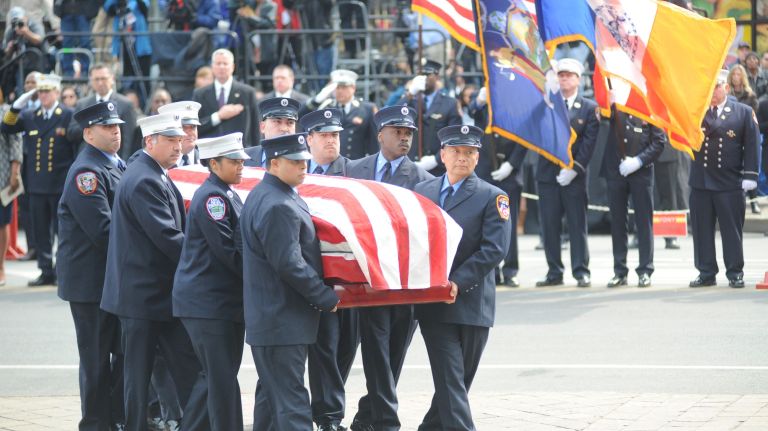 The flag-draped coffin of FDNY EMT Yadira Arroyo is taken into St. Nicholas of Tolentine Roman Catholic Church on University Avenue in the Bronx on Saturday, March 25, 2017.