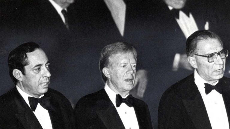 Lt. Governor of New York Mario Cuomo,left, former President Jimmy Carter, center, and Rabbi Israel Mowshowitz, Chairman of the New York Board of Rabbis Centennial Dinner, right, sing the National Anthem at the Waldorf Astoria Hotel in New York City.May 16, 1981