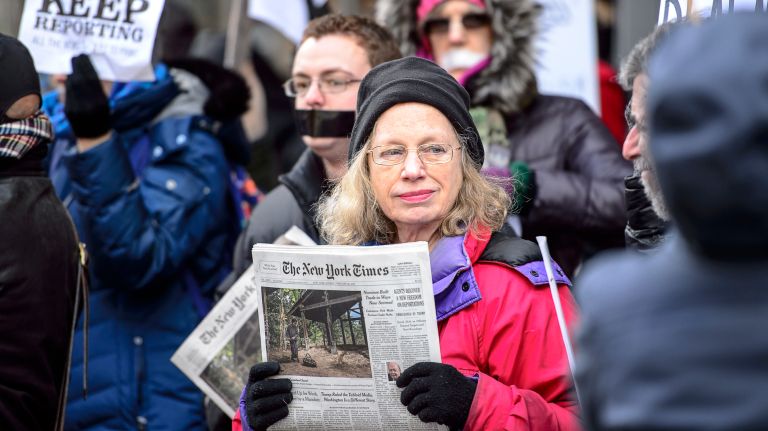 A protester shows support for the New York Times outside the publication's office in midtown Manhattan during the March for a Free Press on Feb. 26, 2017.