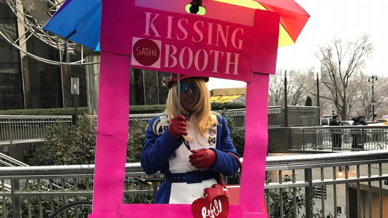 LGBT rally at Trump Tower: Photos of the midtown Manhattan protest 23 Mike Hisey, 54, dons a Kellyanne Conway Inauguration Day-inspired coat while standing inside a makeshift kissing booth at the rally on Feb. 12, 2017.
