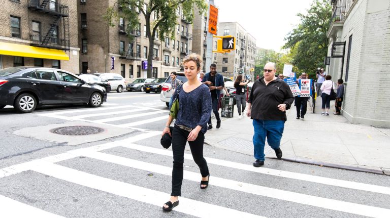 A group of drivers follow TLC Commissioner Meera Joshi from a vigil held in honor of Fausto Luna in Washington Heights.