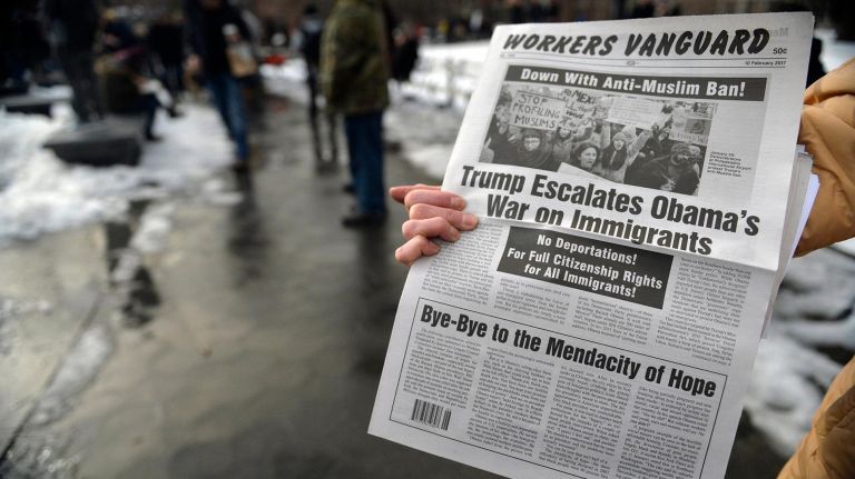 A protester passes out copies of the Workers Vanguard during a rally at Washington Square Park on Saturday, Feb. 11, 2017. The rally is being held to challenge the criminalization of immigrants under the NYPD's current Broken Windows policy, before it worsens under President Trump's far-right administration.