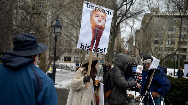 A protester has a message for President Trump during a rally at Washington Square Park on Saturday, Feb. 11, 2017. The rally is being held to challenge the criminalization of immigrants under the NYPD's current Broken Windows policy, before it worsens under Trump's far-right administration.