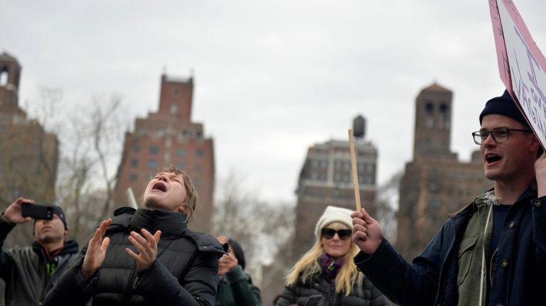 Brookyln resident Emily Smith (26) and other protesters scream out during a rally at Washington Square Park on Saturday, Feb. 11, 2017. The rally is being held to challenge the criminalization of immigrants under the NYPD's current Broken Windows policy, before it worsens under Trump's far-right administration.