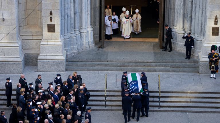 Pallbearers carry the coffin of NYPD Det. Steven McDonald into St. Patrick's Cathedral on Friday, Jan. 13, 2017.