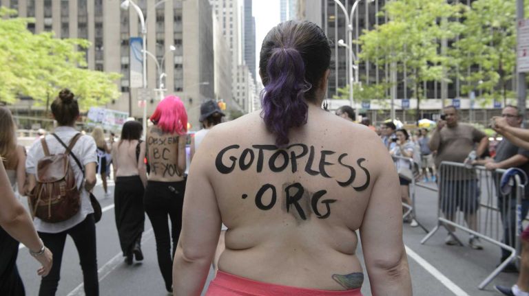 Participants, some topless, march in midtown Manhattan during an event marking International Go Topless Day on Sunday, August 23, 2015. The event was independent of, but coincide with, the apparent proliferation topless tip seeking women in Times Square.