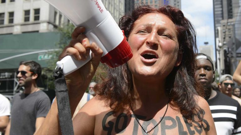 Participants, some topless, march in midtown Manhattan during an event marking International Go Topless Day on Sunday, August 23, 2015. The event was independent of, but coincide with, the apparent proliferation topless tip seeking women in Times Square.