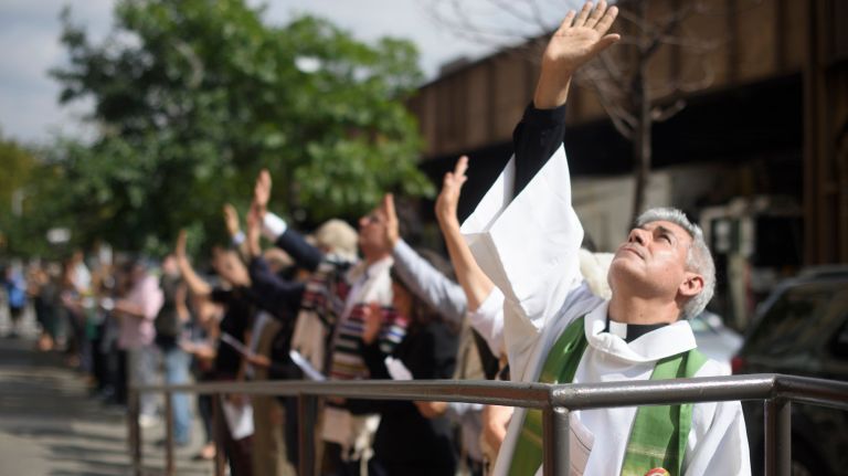 Family separation protest held outside Cayuga Centers in East Harlem 2 Protesters pray silently during a Jericho Walk around the Cayuga Centers facility in East Harlem on Tuesday.