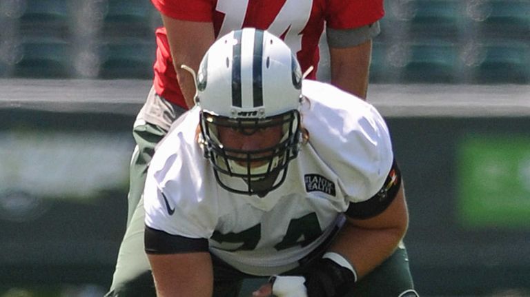 Ryan Fitzpatrick #14, New York Jets Quarterback, back, works on snaps with Center #74 Nick Mangold during the first day of team training camp at Atlantic Health Jets Training Center in Florham Park, NJ on Thursday, July 28, 2016.