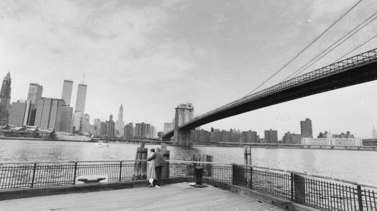 A couple spends time together looking at the New York City skyline from the Brooklyn waterfront on April 20, 1986.