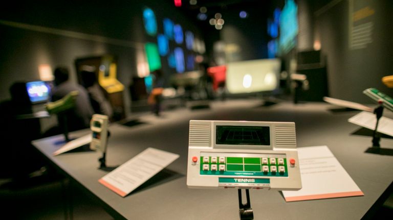 The exhibit displays a host of playable games, including 1980's 