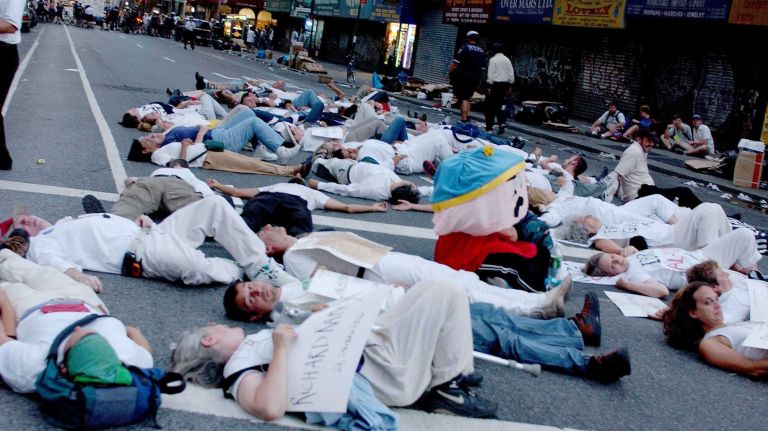 Dozens of protesters lie in the middle of Broadway near 28th Street during a 
