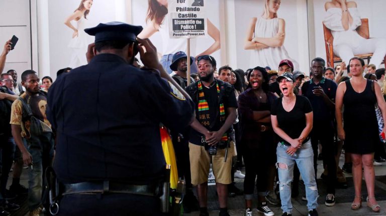 Demonstrators shout during a march through Manhattan on July 7, 2016, to protest the deaths of two black men at the hands of police in Louisiana and Minnesota. 