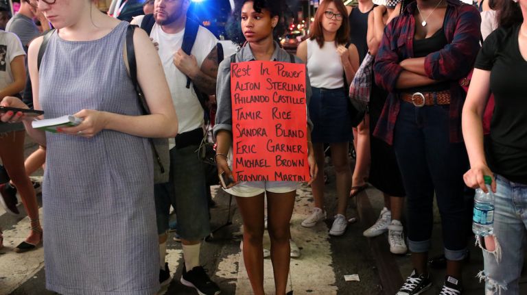 Demonstrators march through Manhattan on July 7, 2016, to protest the deaths of two black men at the hands of police in Louisiana and Minnesota. The sign lists some of the others also killed by police. 