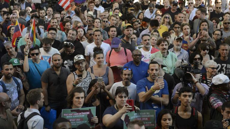 People gather at The Stonewall Inn in Manhattan on Sunday, June 12, 2016, at a vigil for Orlando, Fla., shooting victims. A gunman armed with an assault rifle and handgun killed 49 people and wounded 53 at Pulse, a gay nightclub in Orlando, in what officials termed the worst mass shooting in U.S. history.