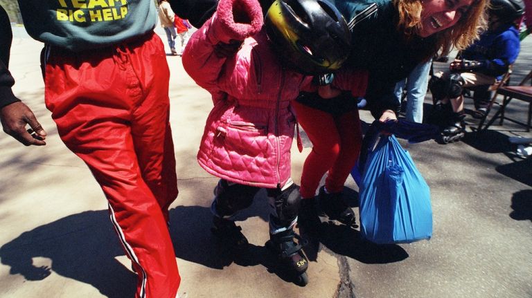 Classic street games: Stickball, handball and more 16 Rosalba Cituertes,right, laughs as she and Ken Harris of Queens Parks and Recreation,left, help Gladielle Cituertes,6, off the court after in-line skating at Victory Ball Fields in Forest Park in 1999.