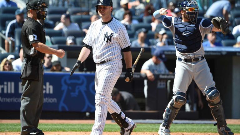 Yankees vs. Rays 58 New York Yankees catcher Brian McCann returns to the dugout after he strikes out swinging against the Tampa Bay Rays during the sixth inning of an MLB baseball game at Yankee Stadium on Sunday, April 24, 2016.