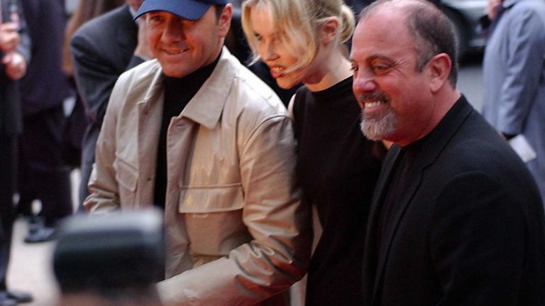 Kevin Spacey, left, and Billy Joel pose for a photo with fashion designer Vassa at the Tribeca Film Festival on May 8, 2002.