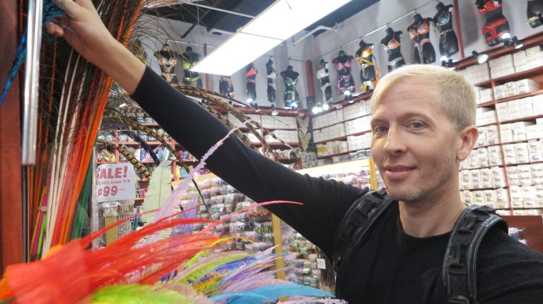 Michael Collins, aka Miss Gay New York America Andora Tetee, picks out some feathers in the Garment District.