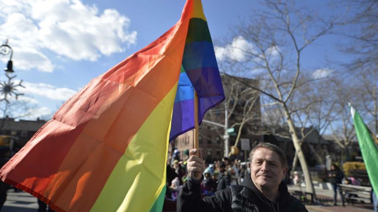 Manhattan resident Robert Pinter, 65, waves a rainbow flag on Sunday, March 6, 2016, as he marches in the St. Pat's for All Parade in Sunnyside and Woodside, Queens.