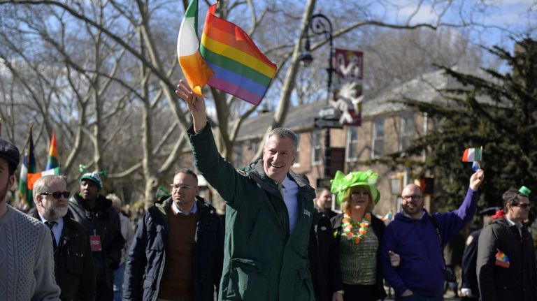New York City Mayor Bill de Blasio waves to the crowd on March 6, 2016, in Sunnyside as he marched along Skillman Avenue in the St. Pat's for All Parade.