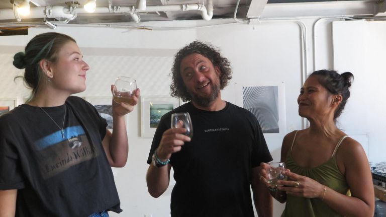 Emily Pennell (from left), Hagai Yardeny and Marie Estrada toast inside M&Ocirc;T&Ocirc; Spirits.