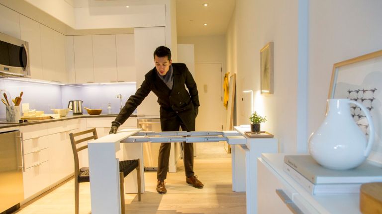  A model unit of nARCHITECTS' Carmel Place is decorated with Resource Furniture, on Jan. 5, 2015. The fully furnished unit enables the living area to convert to a bedroom with a pull on a sofa bed, a coffee table, and a dining table. Carmel Place, which is currently in construction, is the first building to have micro-unit apartments in New York City, and will be one of the first multi-unit Manhattan buildings to be using modular construction.