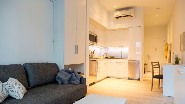  A model unit of nARCHITECTS' Carmel Place is decorated with Resource Furniture, on Jan. 5, 2015. The fully furnished unit enables the living area to convert to a bedroom with a pull on a sofa bed, a coffee table, and a dining table. Carmel Place, which is currently in construction, is the first building to have micro-unit apartments in New York City, and will be one of the first multi-unit Manhattan buildings to be using modular construction.