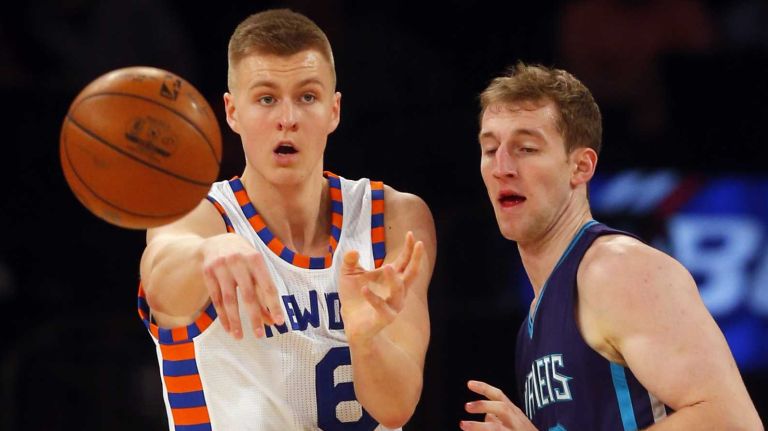 Kristaps Porzingis #6 of the New York Knicks passes the ball in the fourth quarter against Cody Zeller #40 of the Charlotte Hornets at Madison Square Garden on Tuesday, Nov. 17, 2015 in New York City.
