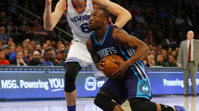 Kemba Walker #15 of the Charlotte Hornets drives to the hoop against Kristaps Porzingis #6 of the New York Knicks at Madison Square Garden on Tuesday, Nov. 17, 2015 in New York City.