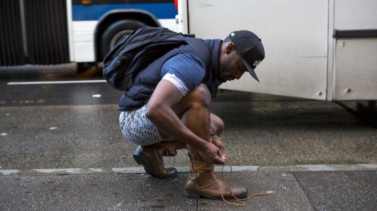 A participant in the No Pants Subway Ride ties his shoelace in his underwear after riding a New York subway on Jan. 10, 2016.