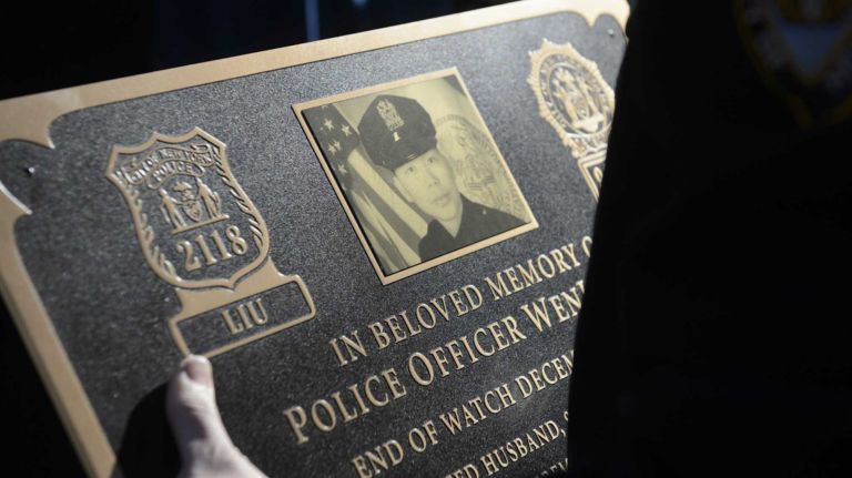 Members of the New York Police Department prepare for a memorial plaque dedication ceremony honoring Detective Wei Tang Liu and Detective Rafael Ramos at the 84th Precinct in Brooklyn on Sunday, Dec. 20, 2015. Liu and Ramos were shot and while in a squad car last December.