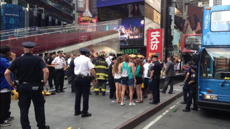 Crowds gather in Times Square after two tour buses collide.