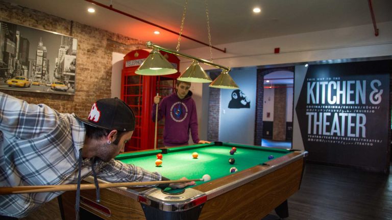 Brothers Federico (left) and Gian Luca of Italy play pool at the HI NYC hostel at 891 Amsterdam Ave. on Nov. 23, 2015.