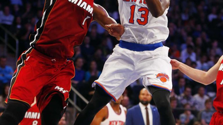 Knicks vs. Heat 17 Jerian Grant #13 of the New York Knicks goes to the hoop against Chris Bosh #1 of the Miami Heat at Madison Square Garden on Friday, Nov. 27, 2015 in New York City.