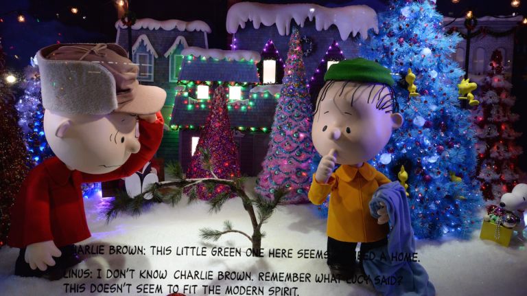 This window depicts the modest, yet classic Christmas tree that Charlie Brown picks out for the play. The tree lot scene features Snoopy, Peppermint Patty, Marcie and Woodstock.