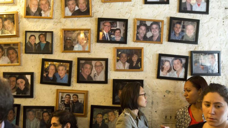 Pictures of celebrities and Joshua Konecy, owner of Eisenburg's Sandwich, are framed on the wall at the diner at 5th Avenue near Flat Iron building in Manhattan on November 5, 2015.