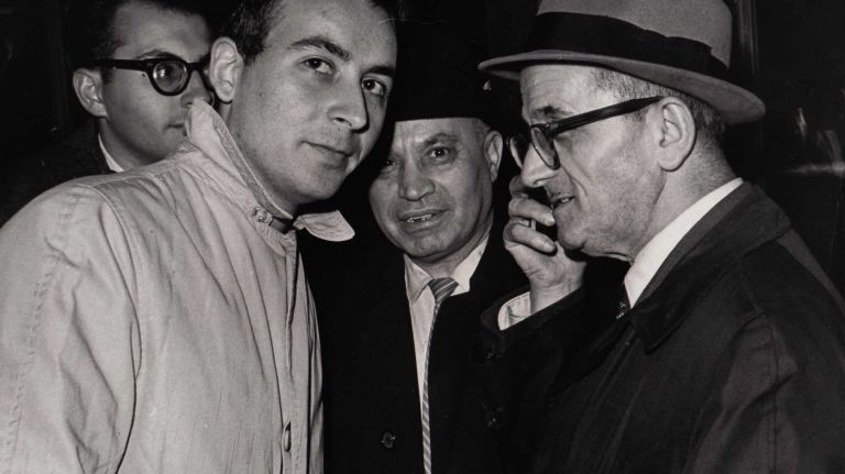 On November 9, 1965, just about the only way to hear the latest news of the blackout was on a small transistor radio. Here four men on W 42nd Street lean in to hear the broadcast.