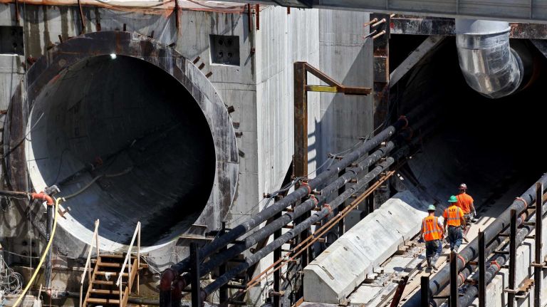 New York, NY - Workers enter tunnel B/C at the Queens work area where TBM machines have been tunneling below street level on the LIRR East Side Access project. Tunnel A is left. This is a few hundred feet from where Chairman Joseph Lhota announced that the last drilling machine completed work on July 22 in tunnel B/C as part of the East Side Access project on the Queens side. A TBM drilling/tunneling machine named 