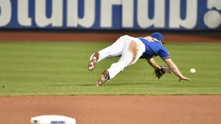 World Series Game 5: Mets vs. Royals 138 New York Mets second baseman Daniel Murphy (28) dives after the ball hit by Kansas City Royals third baseman Mike Moustakas (8) in the seventh inning during Game 5 of the World Series against the Kansas City Royals at Citi Field on Sunday, Nov. 1, 2015.
