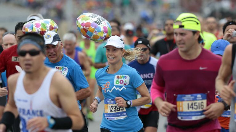 New York City Marathon participants run along the race route in Brooklyn on Nov. 1, 2015.