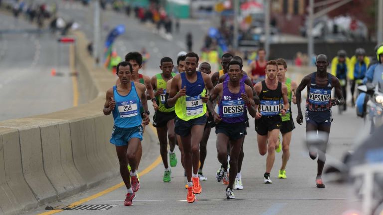 New York City Marathon male participants run along the race route in Brooklyn on Nov. 1, 2015.