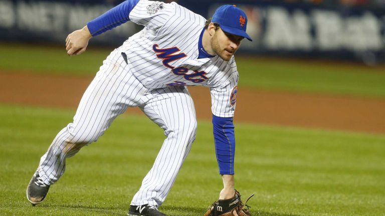 New York Mets second baseman Daniel Murphy (28) with the error on the ball hit by Kansas City Royals first baseman Eric Hosmer (35) in the eighth inning during Game 4 of the World Series against the Kansas City Royals at Citi Field on Saturday, Oct. 31, 2015.