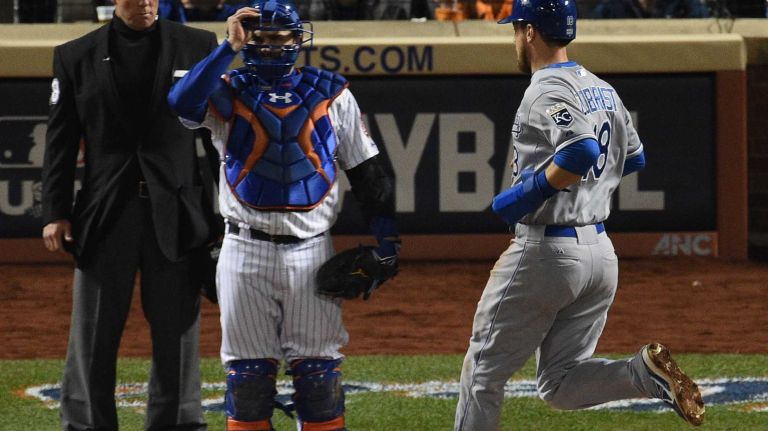 Kansas City Royals second baseman Ben Zobrist scores as New York Mets catcher Travis d'Arnaud looks on during Game 4 of the World Series against the Kansas City Royals at Citi Field on Saturday, Oct. 31, 2015.