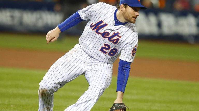 New York Mets second baseman Daniel Murphy makes an error on the ball hit by Kansas City Royals first baseman Eric Hosmer in the eighth inning during Game 4 of the World Series against the Kansas City Royals at Citi Field on Saturday, Oct. 31, 2015.