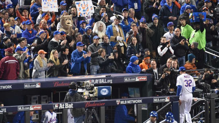 New York Mets fans cheer New York Mets starting pitcher Steven Matz as he walks to the dugout during Game 4 of the World Series against the Kansas City Royals at Citi Field on Saturday, Oct. 31, 2015.