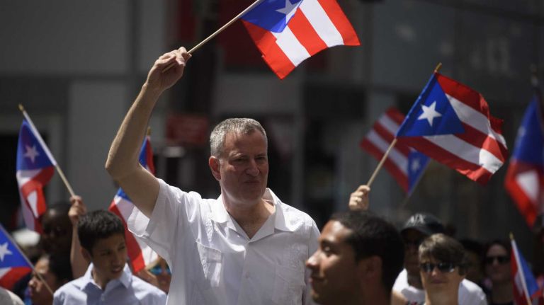 New York City Mayor Bill de Blasio marches along Fifth Avenue during the 58th annual Puerto Rican Day Parade in Manhattan on June 14, 2015. The parade, one of the largest in the city, celebrates Puerto Rican heritage and culture.
