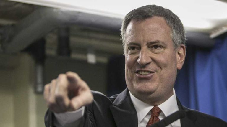 Mayor Bill de Blasio and Housing Authority General Manager Cecil House appear together at a news conference in East Harlem on Saturday, Feb. 8, 2014.