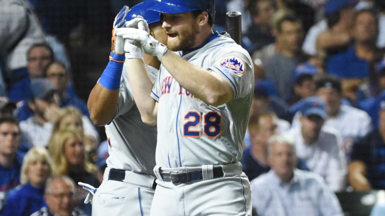 NLCS Game 3: Mets vs. Cubs 52 New York Mets second baseman Daniel Murphy (28) gets a hig- five from New York Mets centerfielder Yoenis Cespedes (52) after hitting a solo home run in the third inning during Game 3 of the NLCS against the Chicago Cubs at Wrigley Field on Tuesday, Oct. 20, 2015.