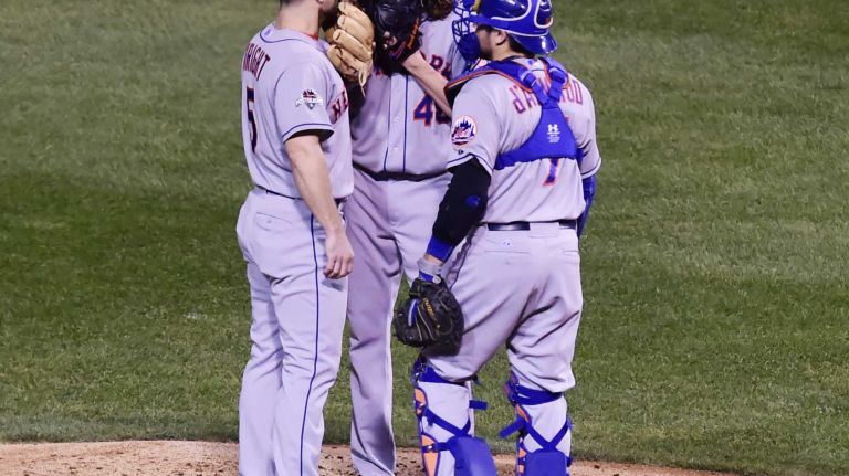 NLCS Game 3: Mets vs. Cubs 56 New York Mets third baseman David Wright (5) and New York Mets catcher Travis d'Arnaud (7) come to the mound to talk with New York Mets starting pitcher Jacob deGrom (48) in the first inning during Game 3 of the NLCS against the Chicago Cubs at Wrigley Field on Tuesday, Oct. 20, 2015.